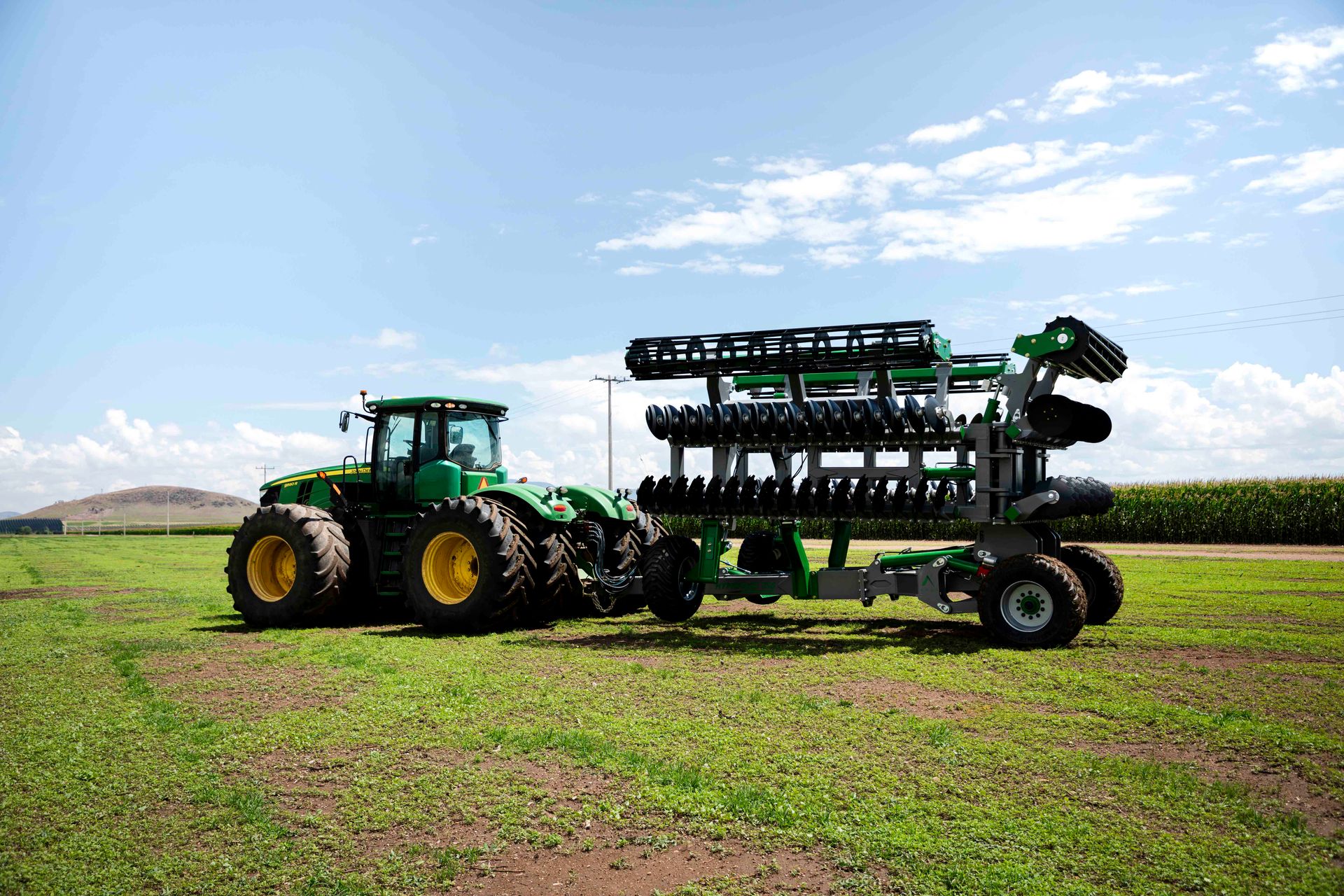APEX Hyperdisc T Series T38 folded behind a John Deere tractor